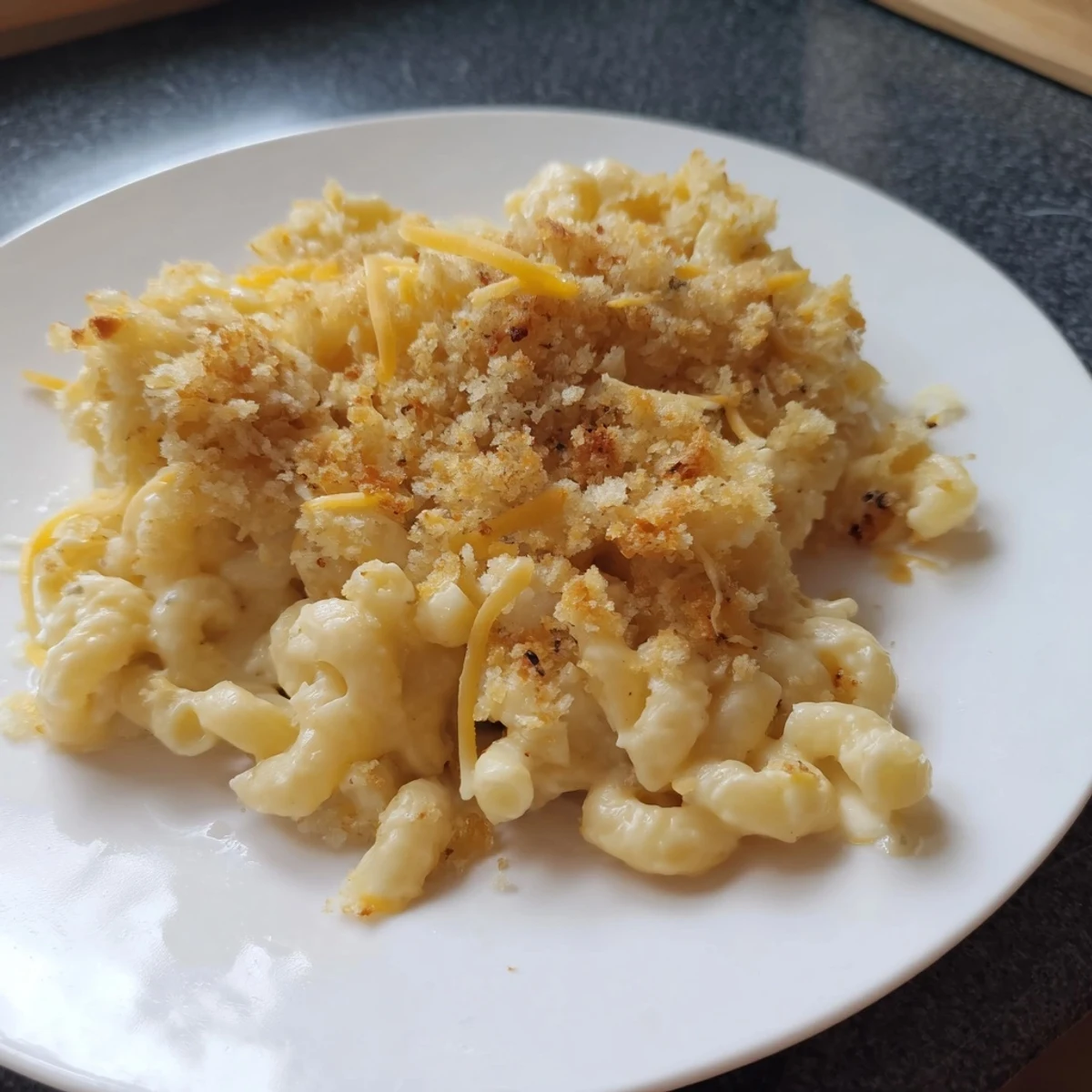 Golden brown crust atop creamy Classic Oven-Baked Macaroni and Cheese, ready to be served hot.