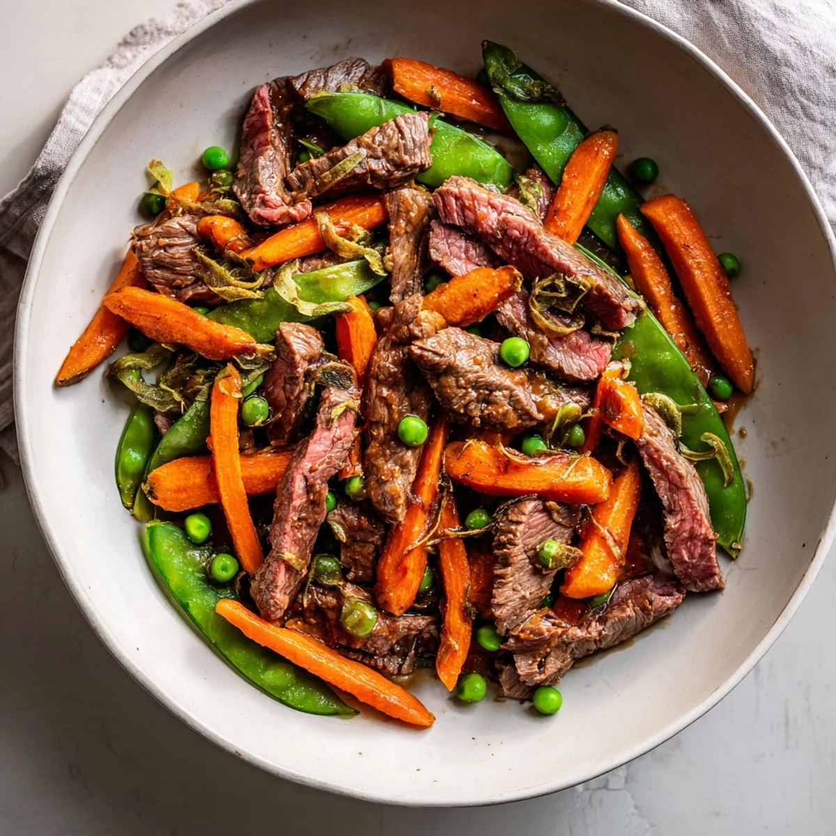 Skillet Beef Stir-Fry with snap peas and carrots, a colorful, savory weeknight dinner.