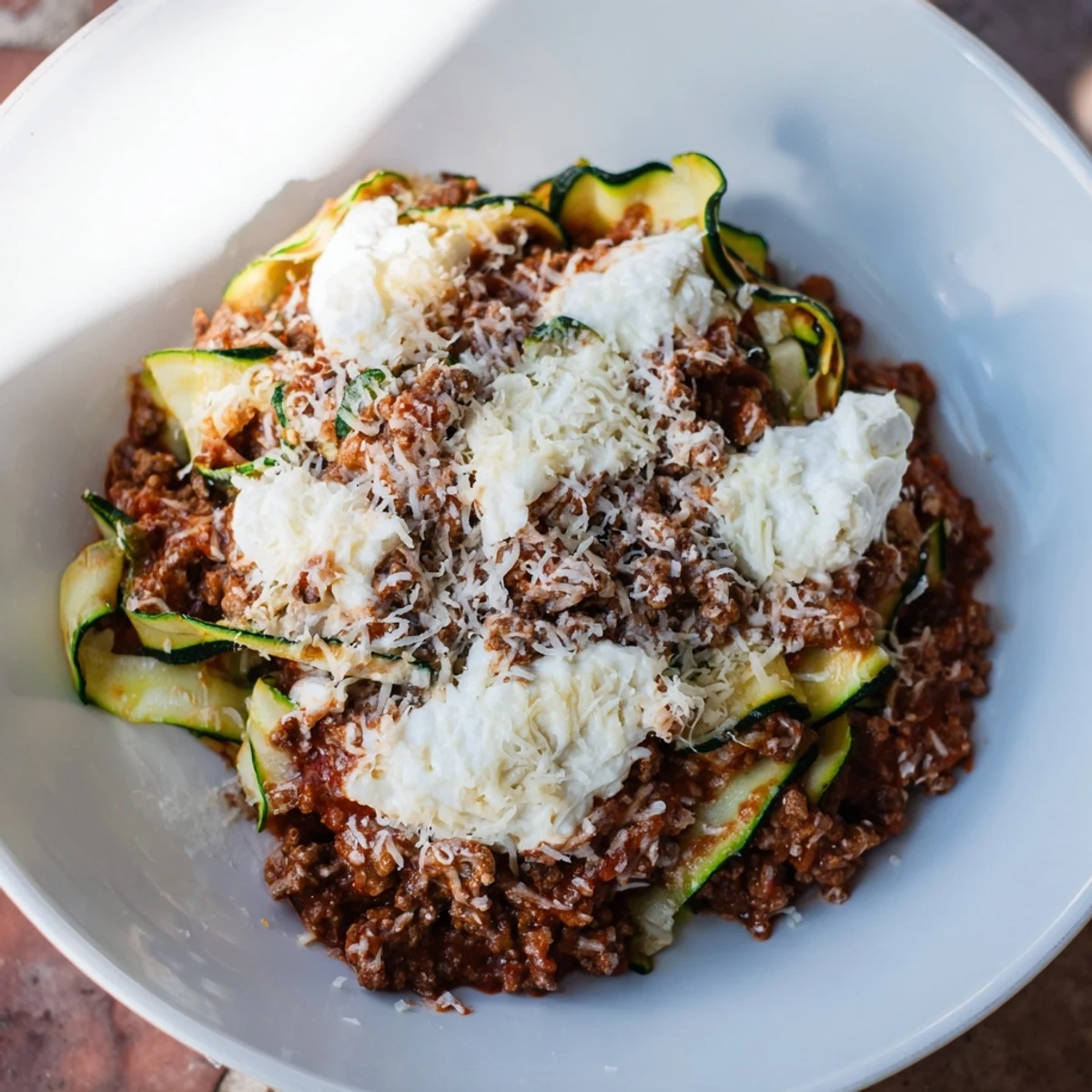 This hearty zucchini lasagna skillet showcases layers of savory ground beef, rich tomato sauce, and creamy ricotta cheese.
