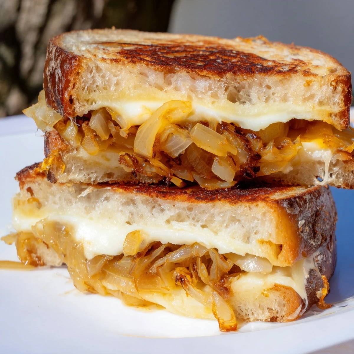 Golden, melty Caramelized Onion and Gruyère Grilled Cheese, with bubbling cheese and caramelized onions.