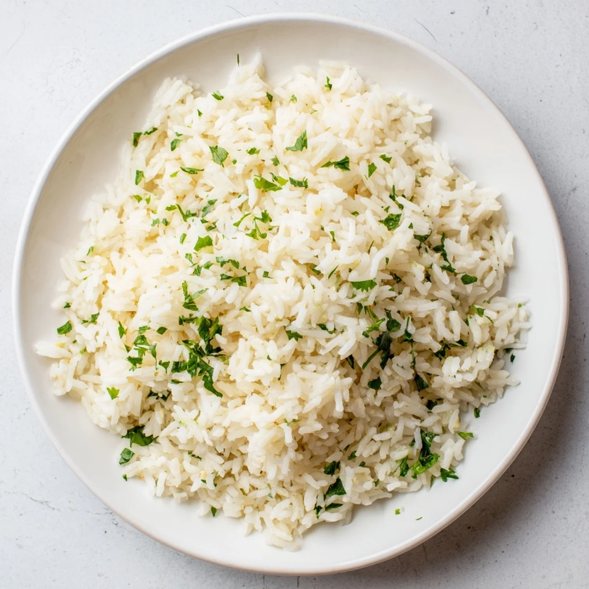 Fluffy garlic butter rice, a side dish, served warm and garnished with fresh parsley.