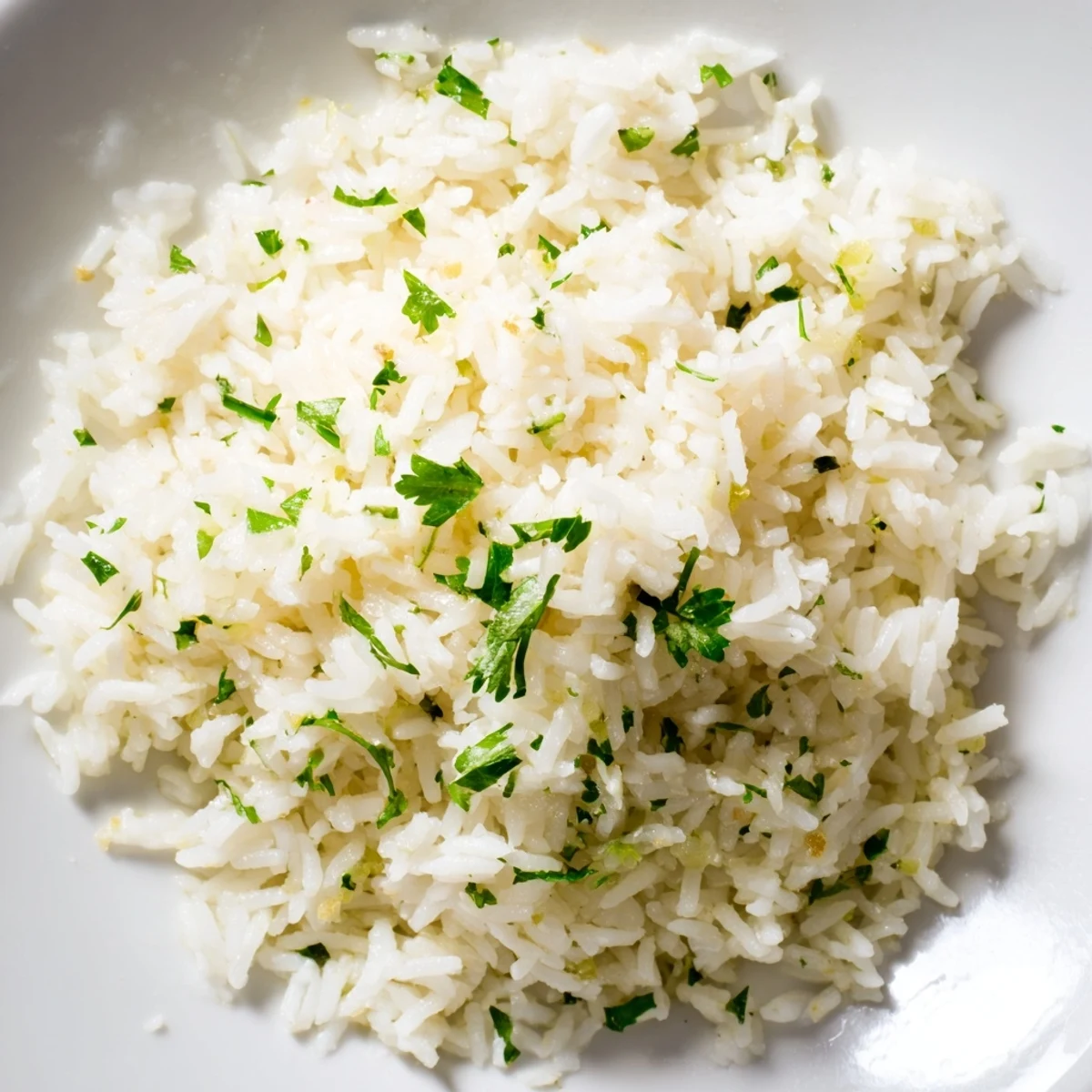 Close-up of savory garlic butter rice, fluffy grains infused with garlic, ready to be enjoyed.