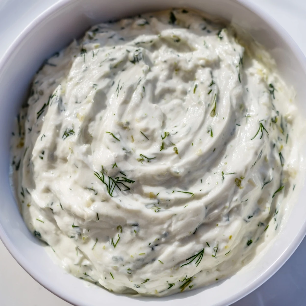 Bright, tangy Greek Yogurt Herb Dip served on a platter with cucumbers, carrots, and radish slices.