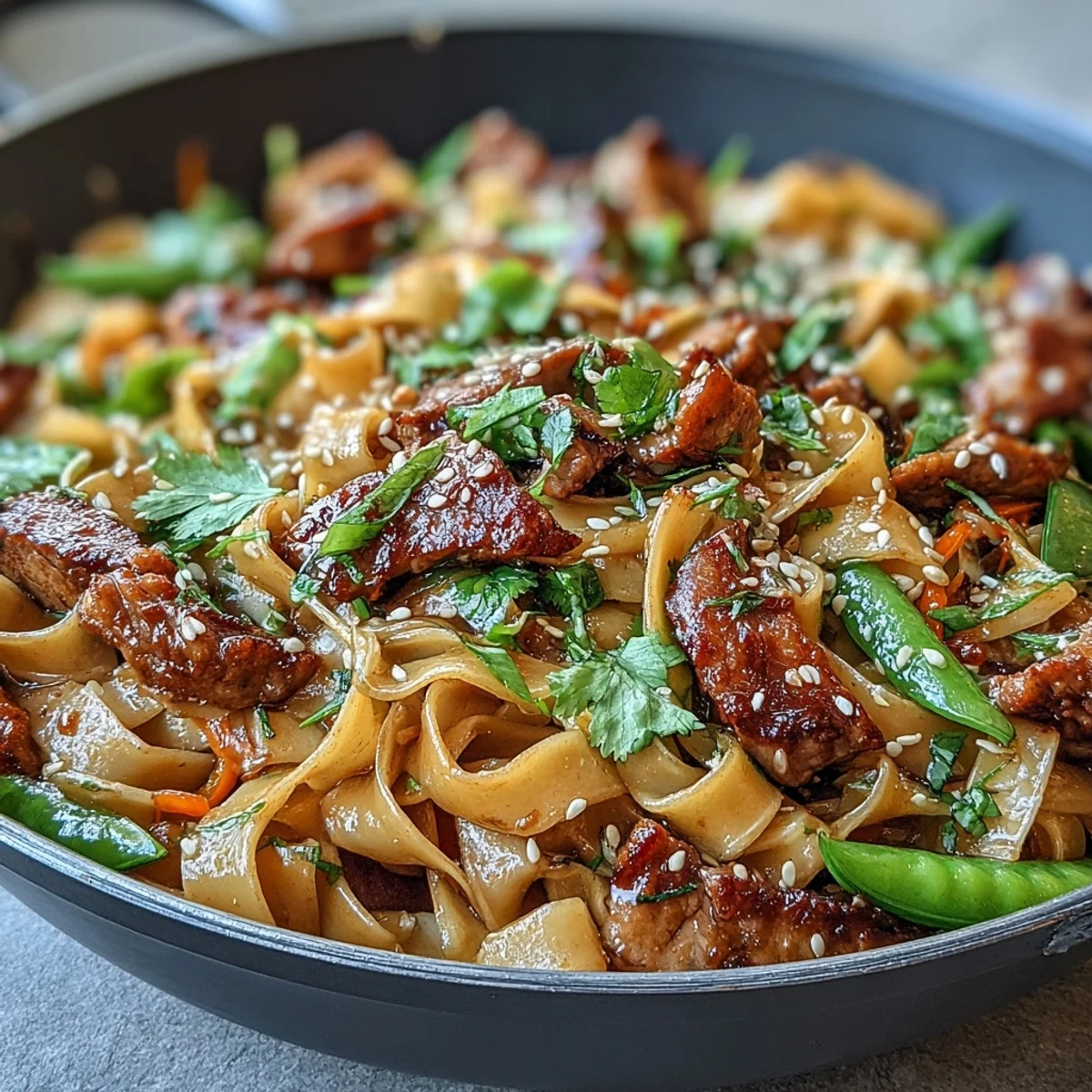 Tender pork, crisp bell peppers, and noodles glisten in a savory sauce, perfect for a quick weeknight Pork Noodle Stir-Fry.