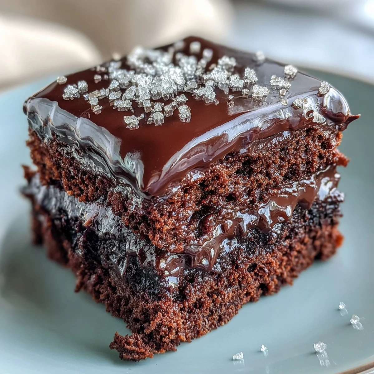 Moist Easy Chocolate Fudge Cake with rich dark chocolate icing, cut to reveal a tender crumb, perfect for a cozy afternoon tea or celebration.