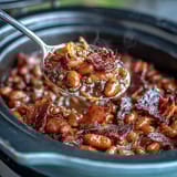 A hearty skillet of Summer BBQ Baked Beans with Brown Sugar and Bacon, bubbling with sweet-smoky sauce and crispy bacon bits.