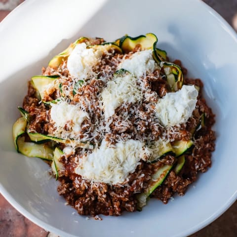 This hearty zucchini lasagna skillet showcases layers of savory ground beef, rich tomato sauce, and creamy ricotta cheese.
