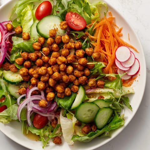 This Mixed Greens Salad features crunchy chickpea croutons atop a bed of fresh, tender greens.