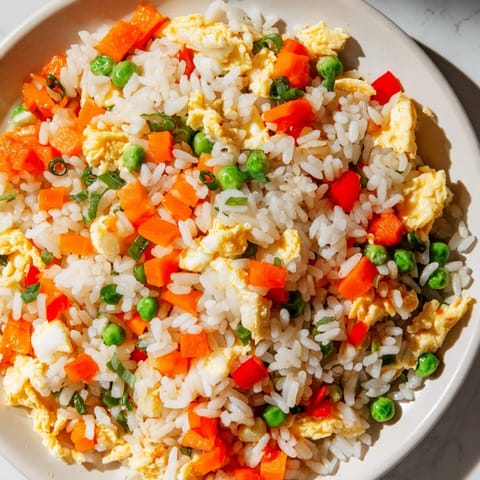 A steaming bowl of flavorful Egg Fried Rice, a quick and easy weeknight dinner idea.