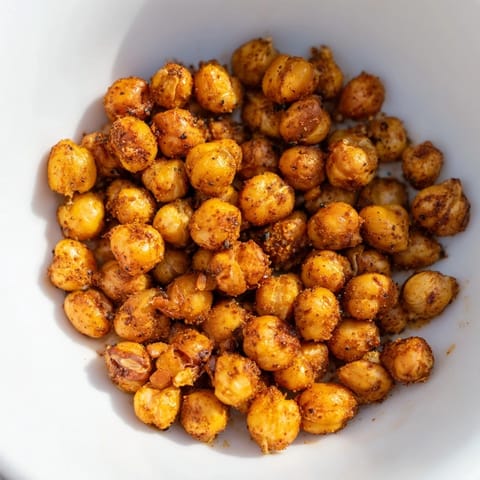 A close-up of a vibrant salad topped with roasted crispy chickpea snack for extra crunch and flavor.
