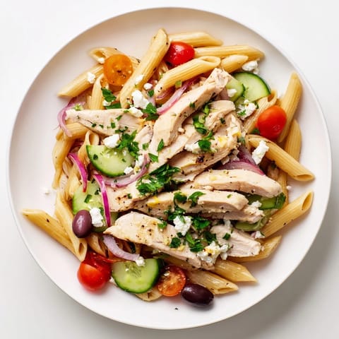 Tender grilled chicken and vibrant cherry tomatoes shine in this Greek Chicken Pasta Bowl, tossed with crisp cucumber and creamy feta.