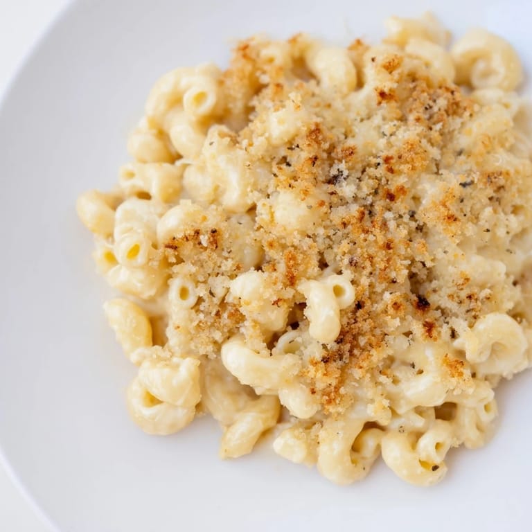 A close-up view of steaming, cheesy Classic Oven-Baked Macaroni and Cheese, a family favorite.