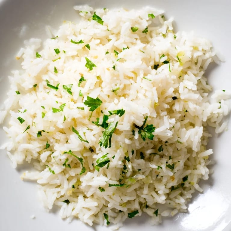 Close-up of savory garlic butter rice, fluffy grains infused with garlic, ready to be enjoyed.