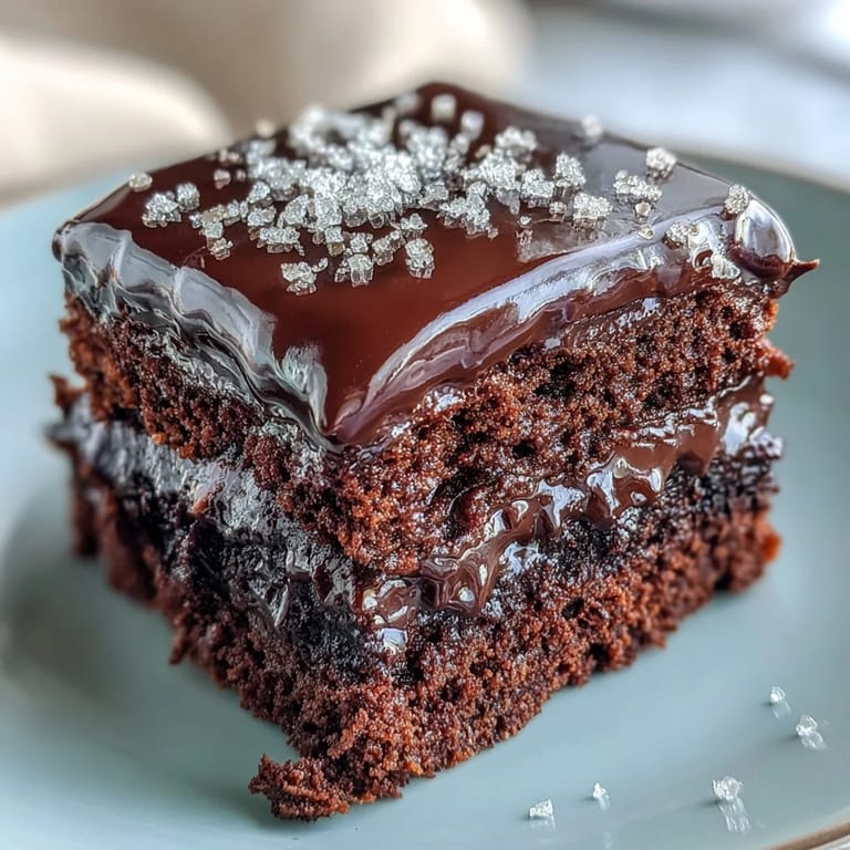 Moist Easy Chocolate Fudge Cake with rich dark chocolate icing, cut to reveal a tender crumb, perfect for a cozy afternoon tea or celebration.
