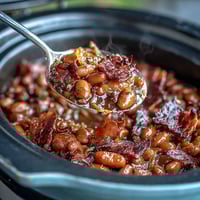 A hearty skillet of Summer BBQ Baked Beans with Brown Sugar and Bacon, bubbling with sweet-smoky sauce and crispy bacon bits.